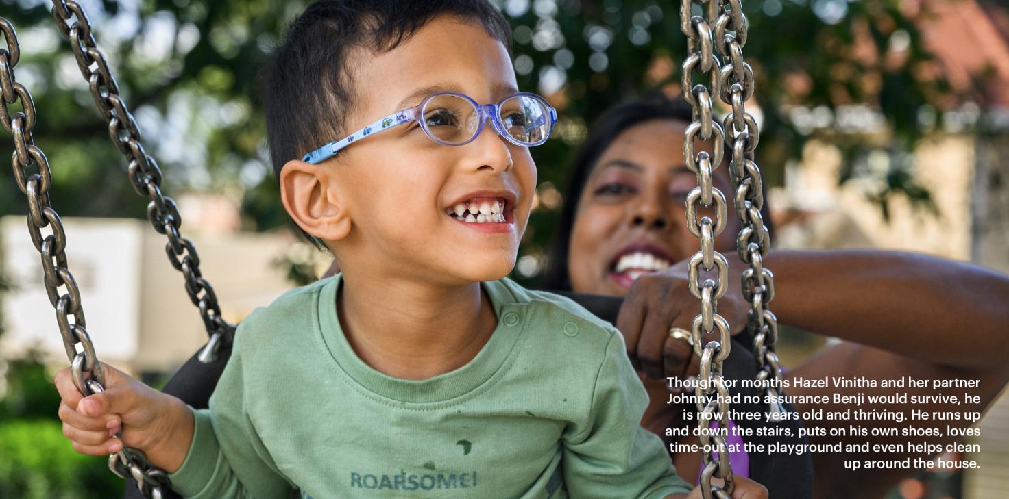 Hazel pushes her son Benji on a swing at the park