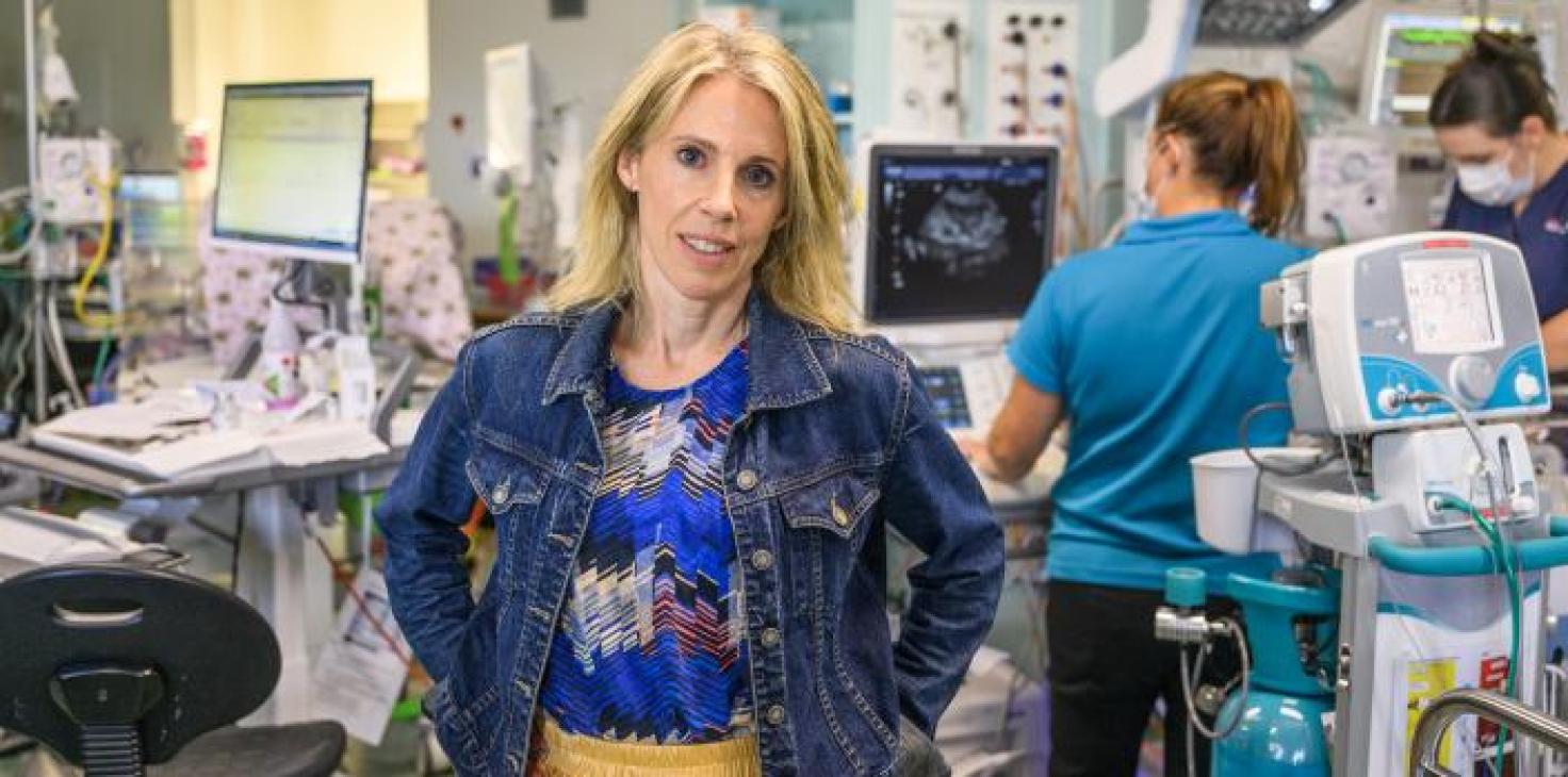 Sophie stands in a hospital surrounded by equipment 